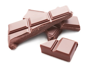 Delicious milk chocolate pieces on white background