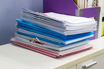 stack of papers documents on file cabinet in Office at offices, business concept.