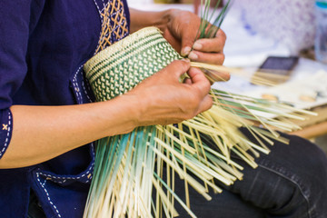 Motion Image - hand of woman holds The villagers took bamboo stripes to weave into different forms for daily use utensils of the community’s people in Bangkok Thailand, Thai handmade product.  