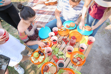 Young people having barbecue party outdoors