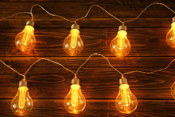 Christmas lights on wooden background