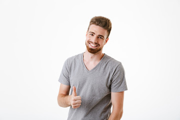 Happy young man make thumbs up gesture.