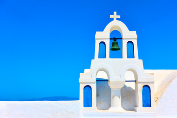 Small white bell-tower in Santorini