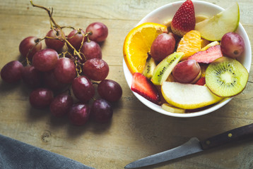 tropical fruit salad on wooden background