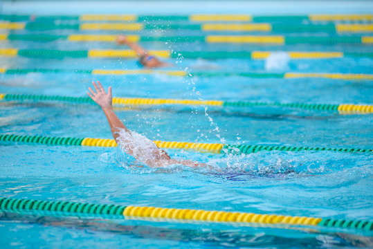 .Swimmer swimming competition in the pool is not identifiable.