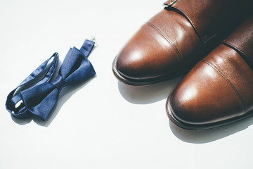 Groom shoes and tie on white background