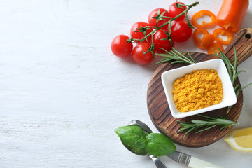 Various spices with vegetables on wooden background