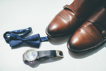 Groom shoes and tie on white background