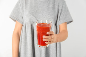 Woman holding glass with tasty smoothie on white background