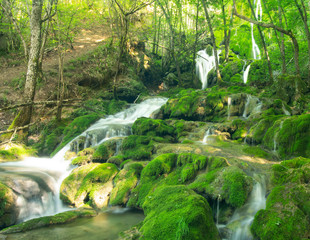 Cascade falls over mossy rocks. Landscape of waterfall in &Aacute;lava, north Spain. Long exposure.