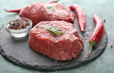 Fresh raw meat with spices on slate plate