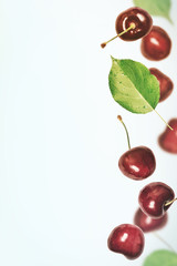 Summer vertical berry  background. Cherry flies  border. Toned