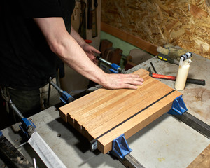 Bonding of parts for the neck, the headstock of the neck and the heel of the neck. Master making a classical guitar.