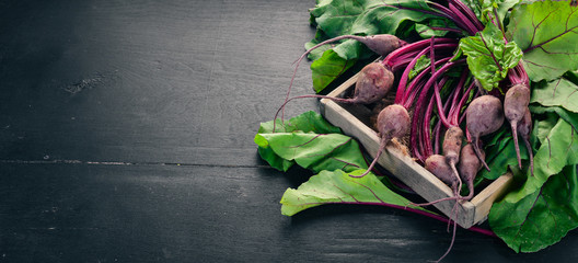 Fresh beets in Wooden Box. On a wooden background. Top view. Copy space.