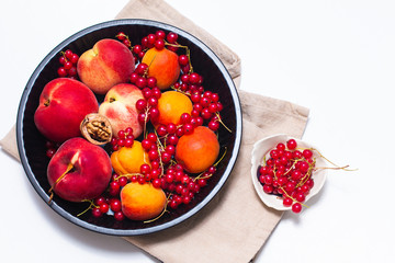 Healthy food concept Summer fruits Peach, apricot and red currant burry in pie pan