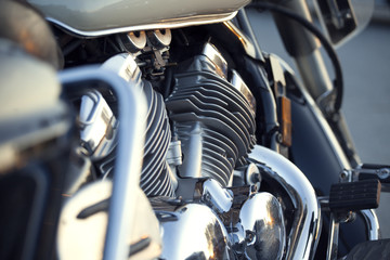Close up view of a shiny chrome motorcycle design engine with exhaust pipes
