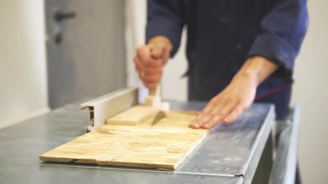 Carpenter processing wood details using industrial cutting machine