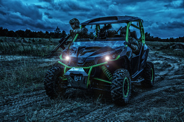 Commandos quick reaction group, special operations forces mobile team riding on fast attack vehicle or military sandrail during night patrolling in bad weather conditions. Raid under cover of darkness © Getmilitaryphotos