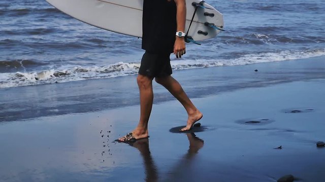Surfer with surfboard gonna surf spot, walk near beach, Bali