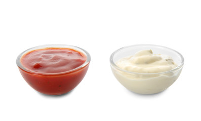 Two bowls with tasty sauces on white background
