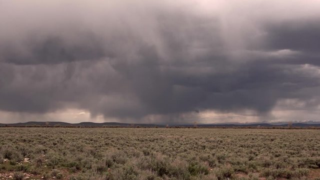 Storm clouds moving across the landscape over sagebrush in Wyoming.