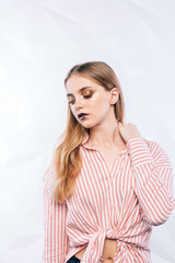 Obraz premium Expressive facial expressions.Girl fashion model with purple makeup.closeup beauty portrait of young woman with bright makeup on white background