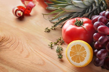 Fresh fruits and tomato on wooden table. Healthy food concept