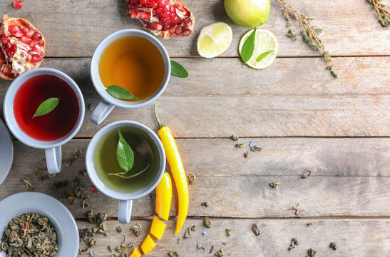 Composition With Cups Of Hot Aromatic Tea On Wooden Table