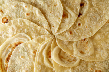 Mexican tortilla wrap background or texture top view. - obrazy, fototapety, plakaty