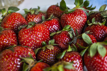 Fresh strawberries arranged in a plate. Selective focus.