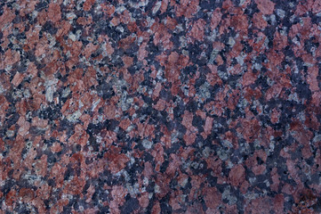 Marble with red, black and white particles