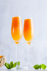 Italian Bellini alcoholic cocktail made from sweet ripe melon with basil flavor. Ideal drink for snacks
