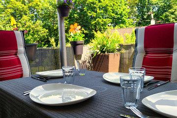 Covered balcony table with white plates