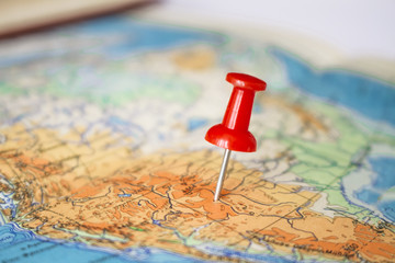 Red pushpin on map on map.Concept of travelling