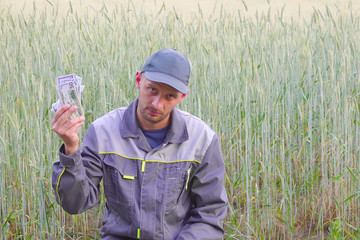 young farmer has a lot of money. The concept of success of business in agriculture.