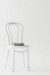 front view of chair with two books isolated on grey background