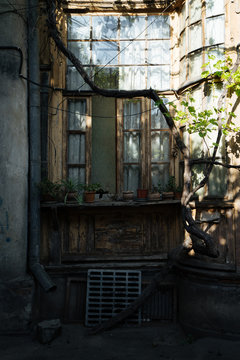 Old wooden window with flower pots