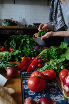 Fototapeta Woman cooking fresh vegetables