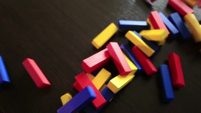 Jenga colored wooden tower crumbles after block move (1080p, 50fps)
