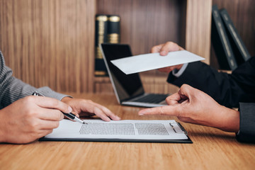 Hand of employer filing final remuneration after employee to write a document letter of...