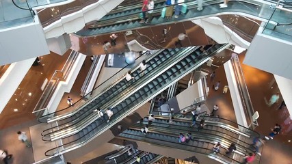 Time lapse escalators in modern shopping mall crowd of people. Very busy full of clients mall complex. Сonsumption concept