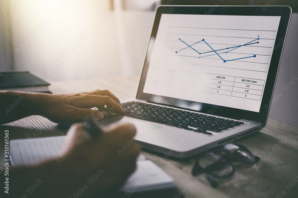 Poster professional at work, businessman writing report and using laptop working analysis investment connec