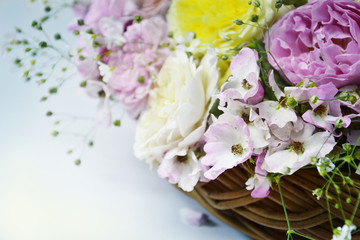 English roses in basket on neutral background