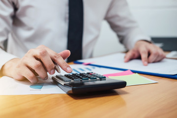 Business man or accountant working Financial investment on calculator with calculate Analyze...