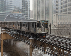 Naklejka premium Train entering city in snow