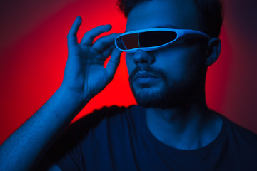 Man in virtual reality glasses in neon light