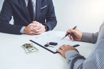Man customer signing car document contract agreement, successful car loan contract buying or...