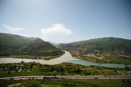 Picturesque mountainous landscape with river and town