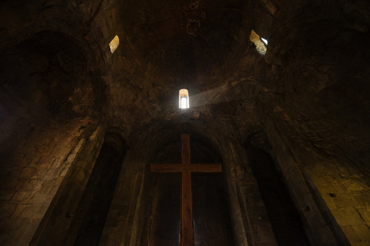 Wooden Christian cross in dark temple