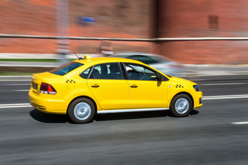 Fototapeta na wymiar yellow taxi cab speeding